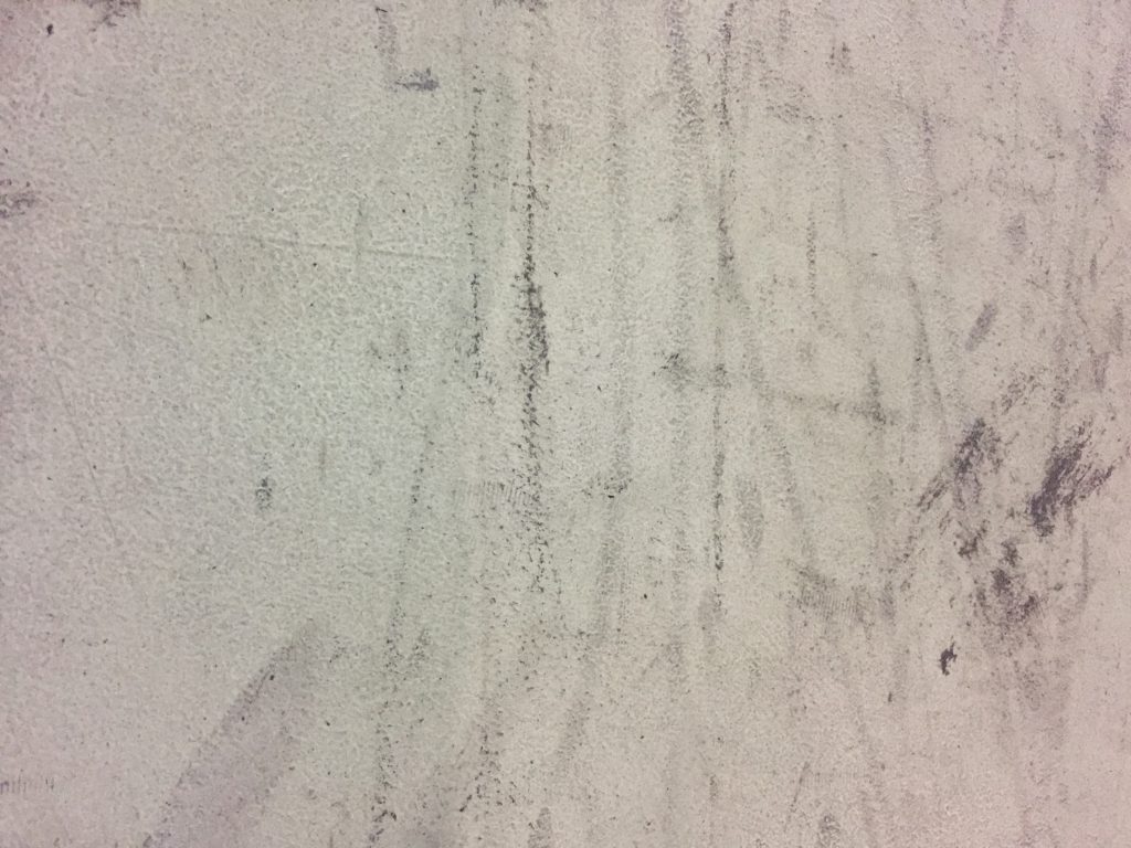 Dirty white surface with black scuffs