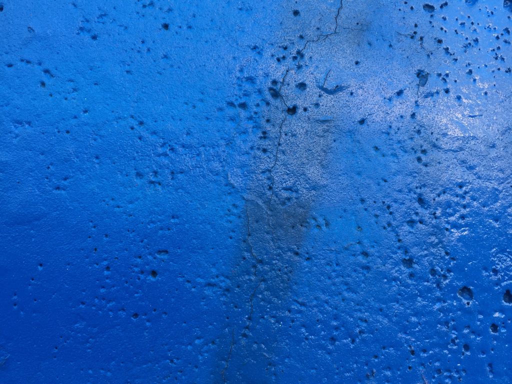 Concrete wall with blue paint