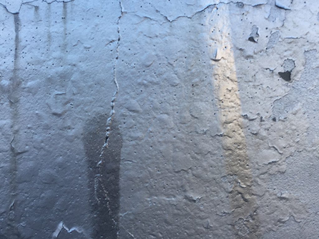 Cracks and paint bubbles on wall
