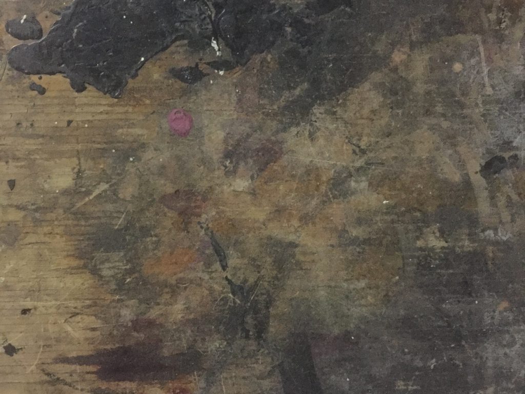 Detailed shot of old wood table covered in paint, mainly black