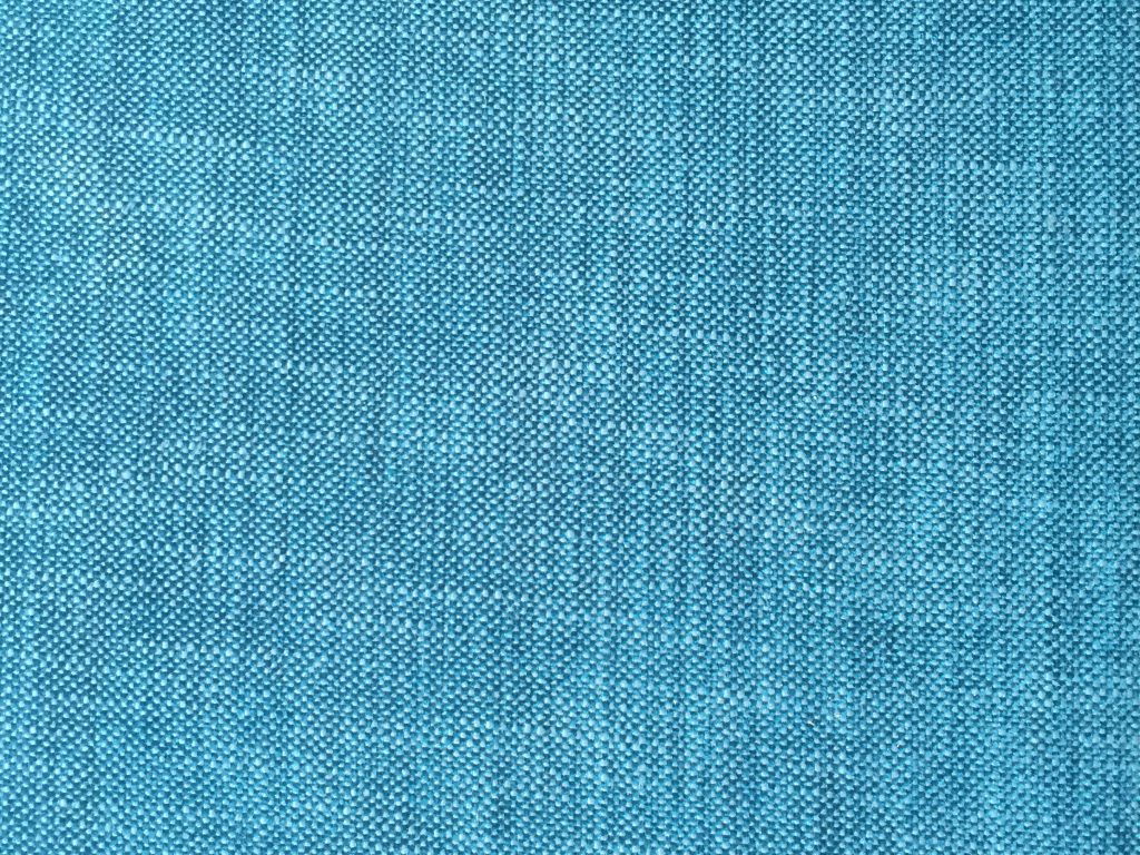 Bright teal fabric with detailed stitching of knit cloth