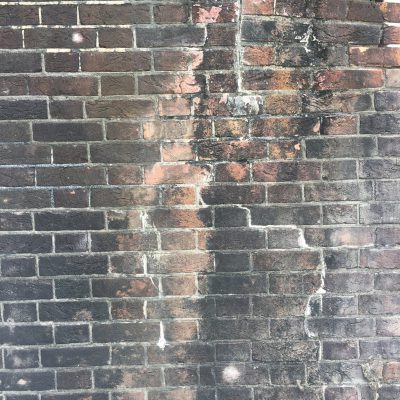 Cracked and dirty brick wall
