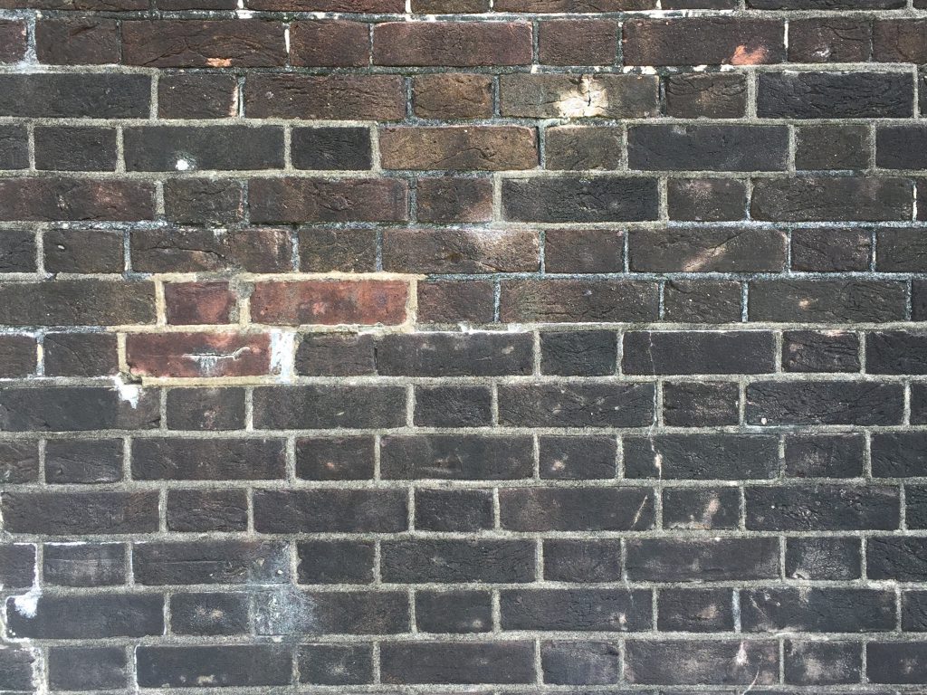 Wide shot of black brick wall