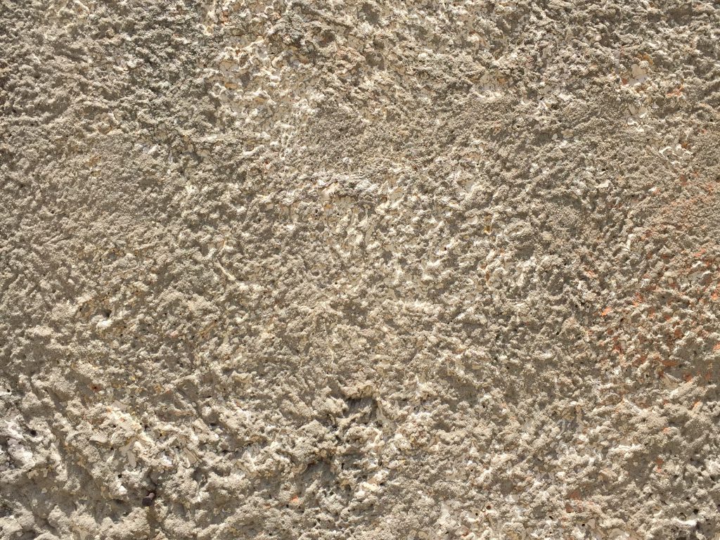 Off white stucco that has very coarse texture