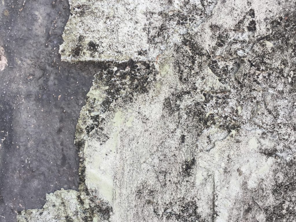 White plaster wall with layers and dirt