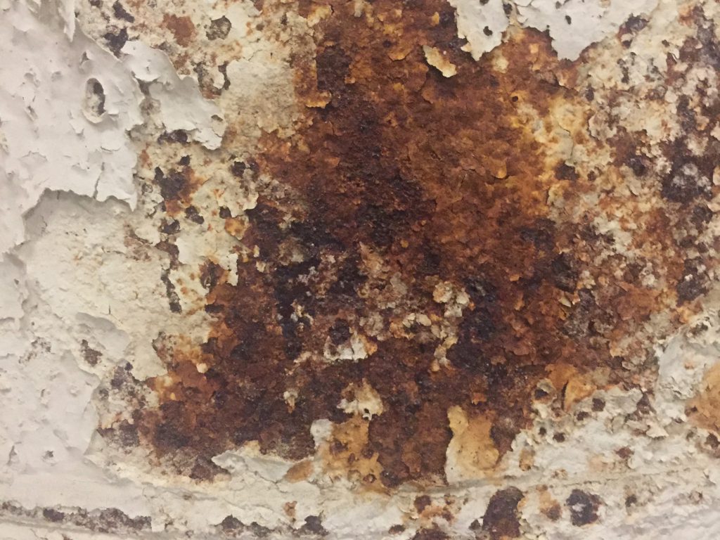 Red rust bleeding through chipping paint
