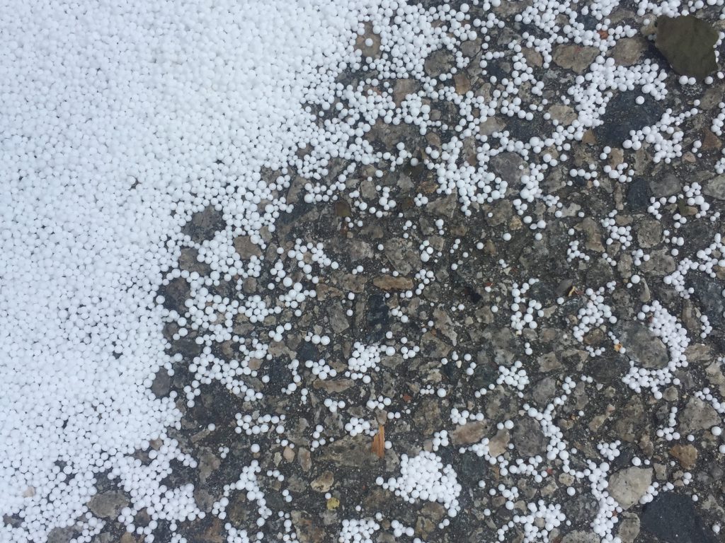 Tiny white balls over concrete