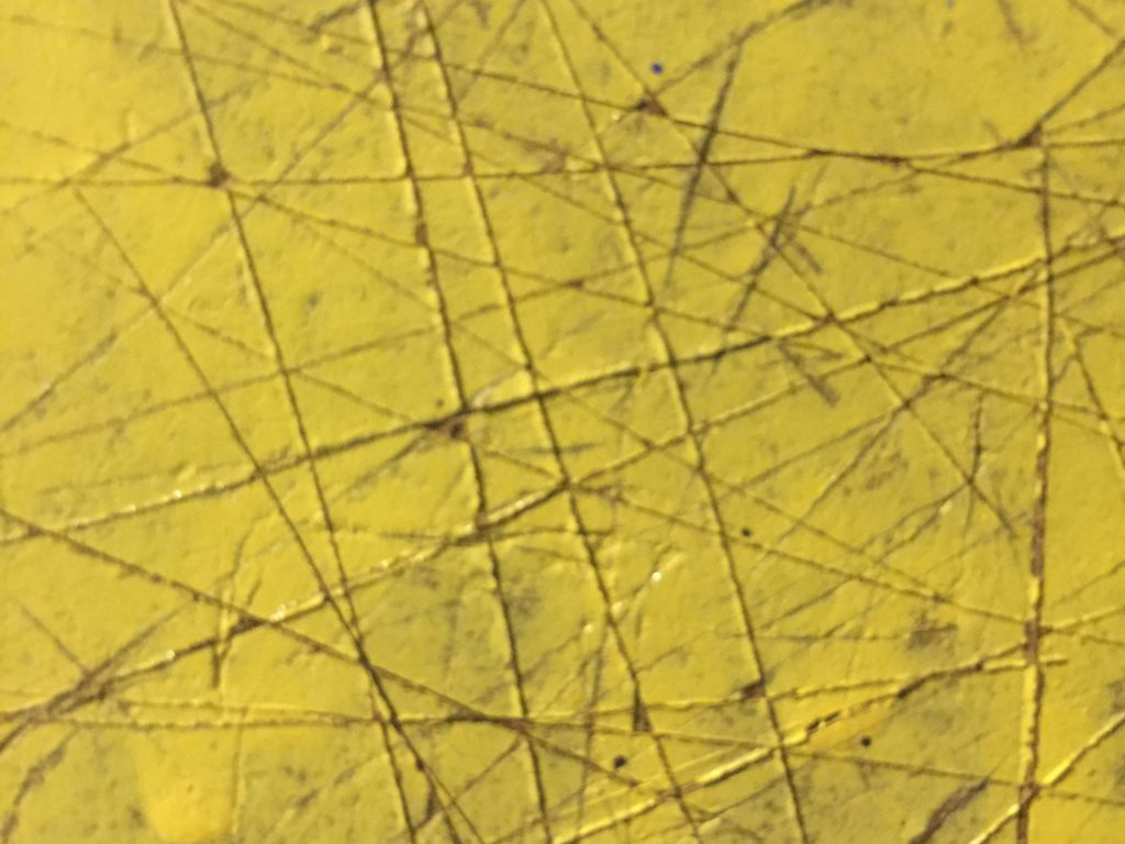 Yellow acrylic paint with score marks