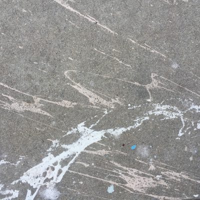 Dark concrete with white paint splatter