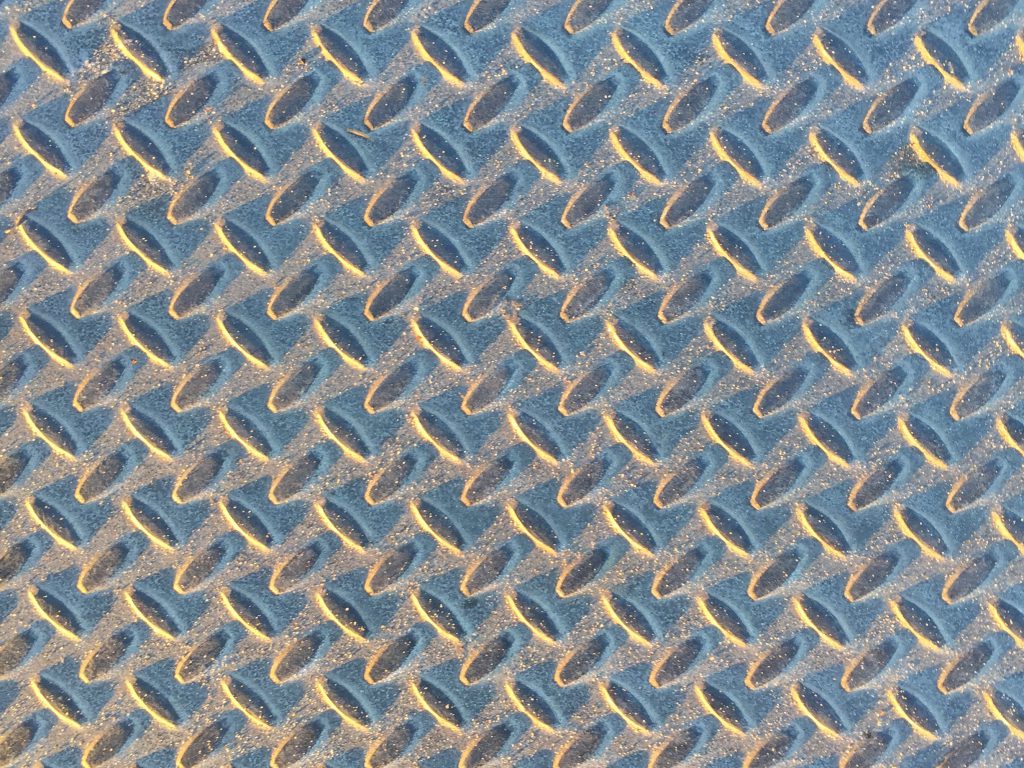 Metal pattern covered in sand