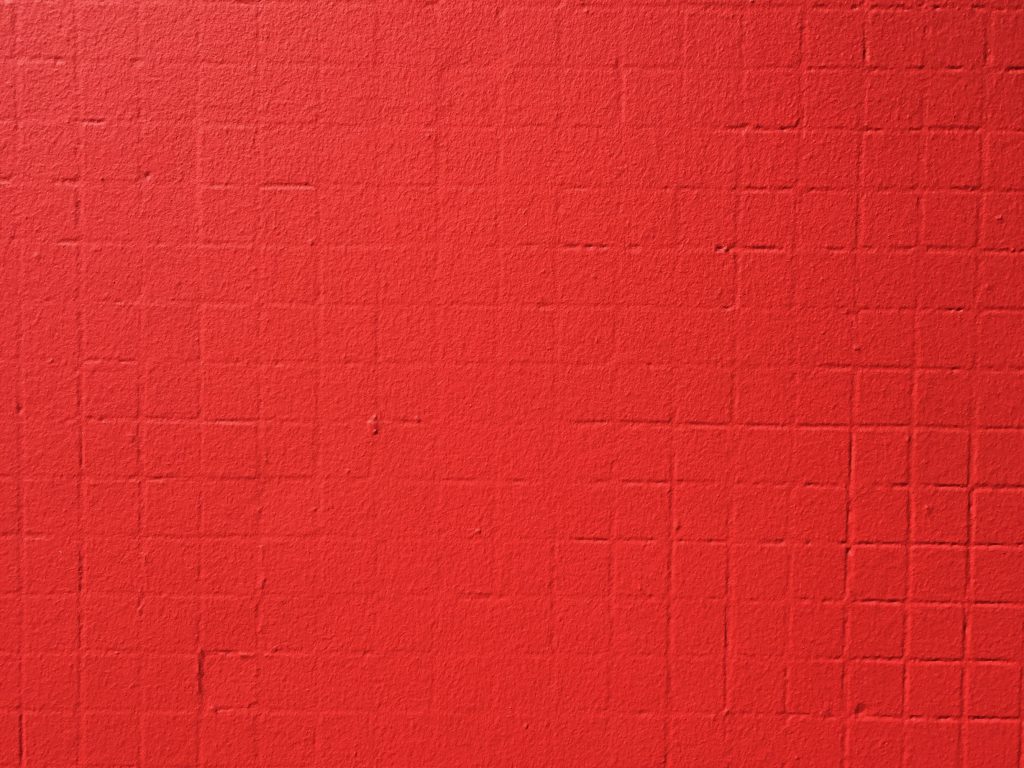 Vivid red paint on concrete wall