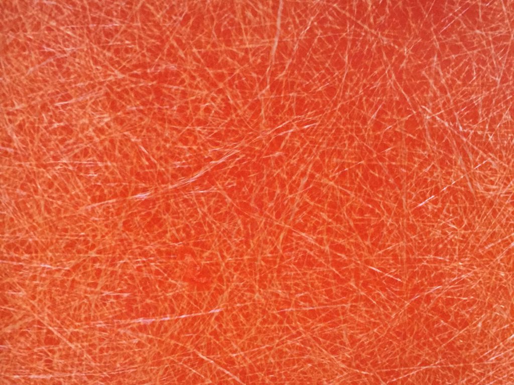 White scratches on orange plastic