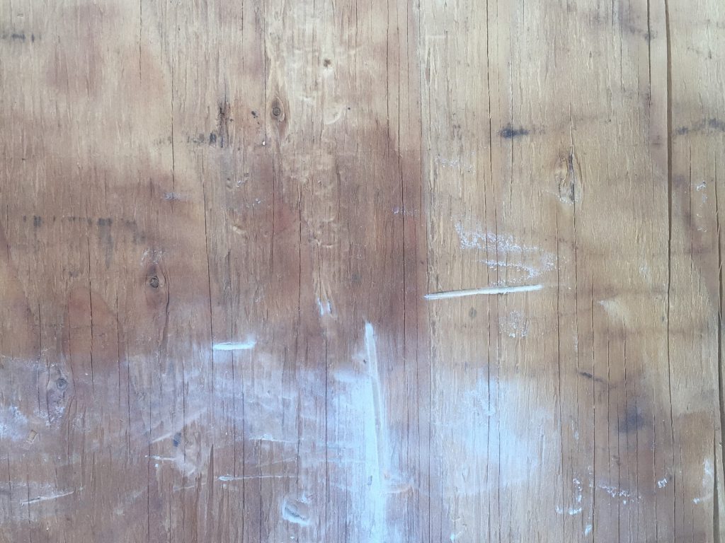 Plywood with cracks and white paint