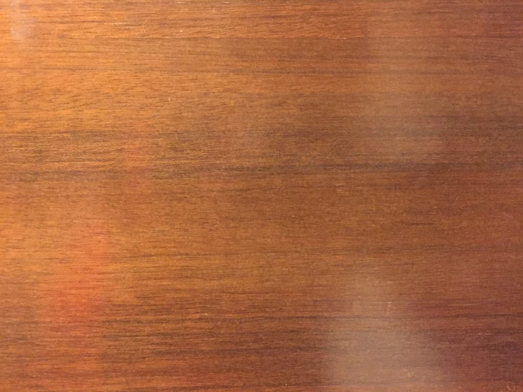 Cherry red stain on smooth wood surface