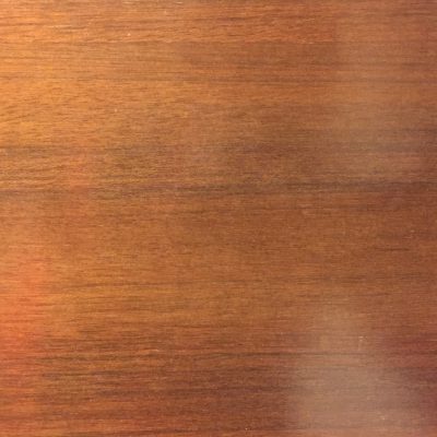 Cherry red stain on smooth wood surface