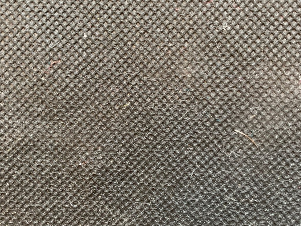 Extreme close up of dirty grey colored paper with visible corrugated pattern