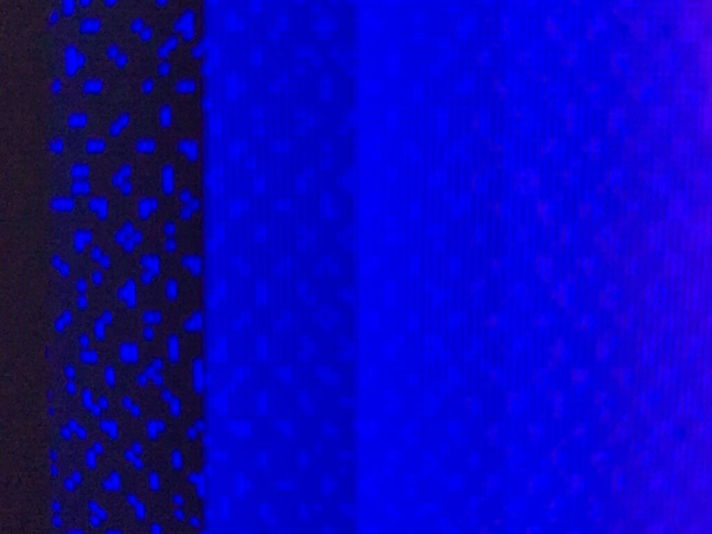Digital pixelation with columns of blue ranging from dark to light