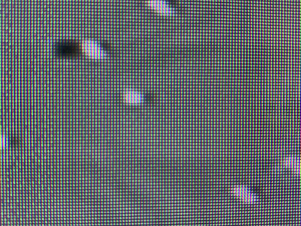 Bumps of white on light green pixel grid