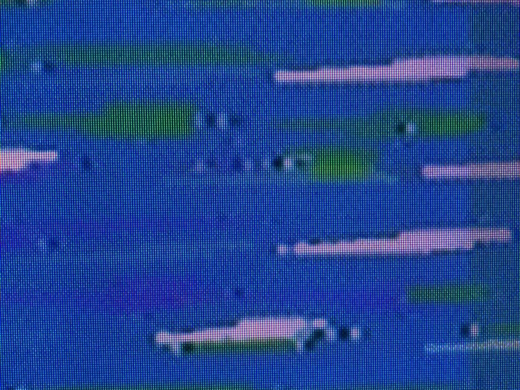 Green and pink shapes over blue digital pixel grid