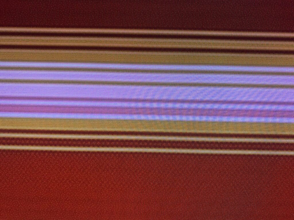 Dark red digital pixel grid with bands of white, pink and orange/yellow