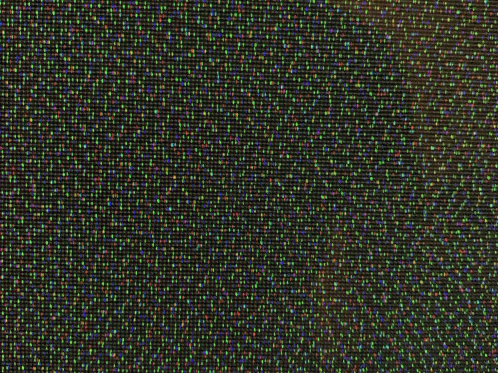 Green red and blue pixels over black background