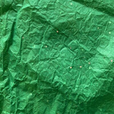 Soft bright green paper with bits of white glitter