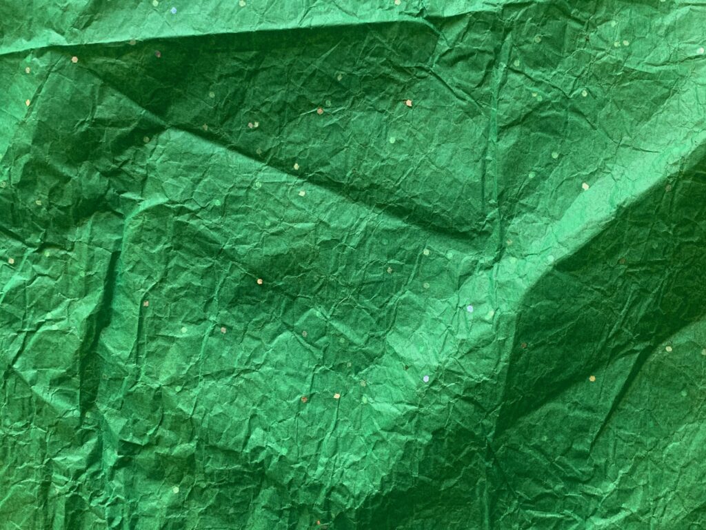 Crumpled and wrinkled thin green wrapping paper