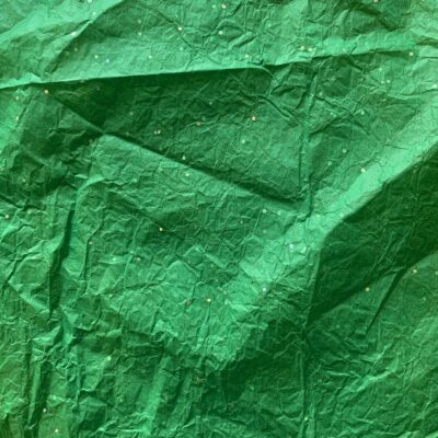 Crumpled and wrinkled thin green wrapping paper