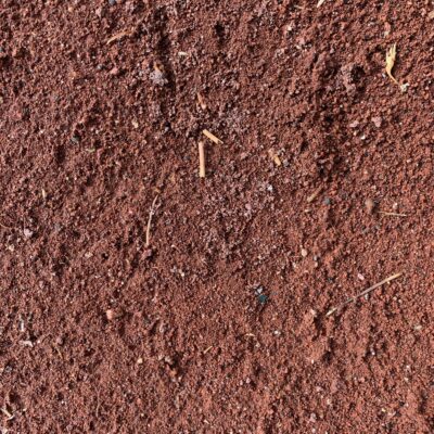 Redish-brown fine dirt with mixture of debris