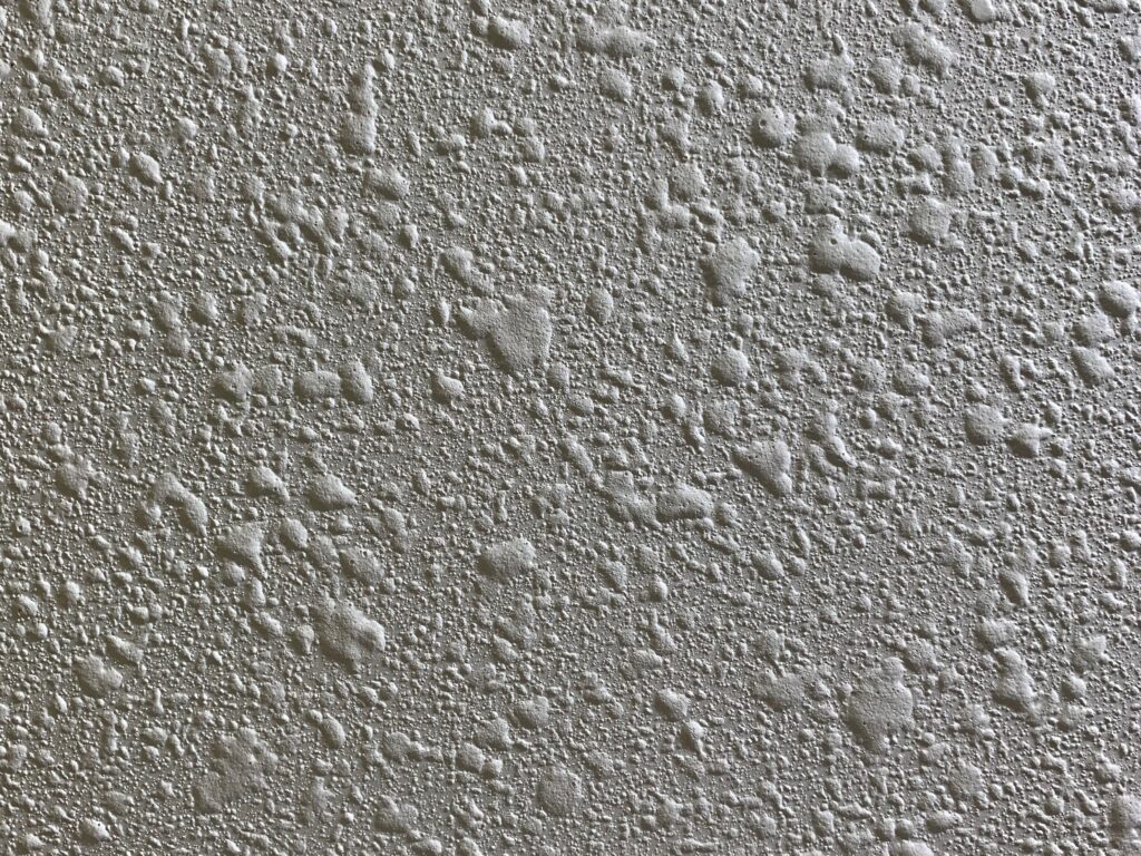 Bumpy white wall with organic like shapes varying in size