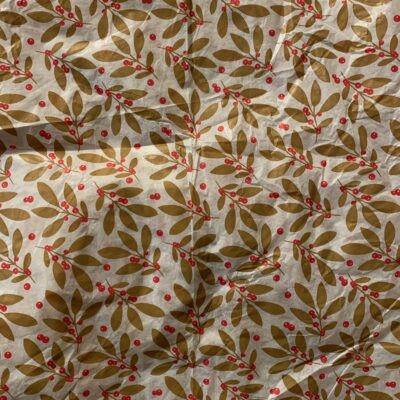 Decorative white gift wrap paper with golden floral pattern with red berries