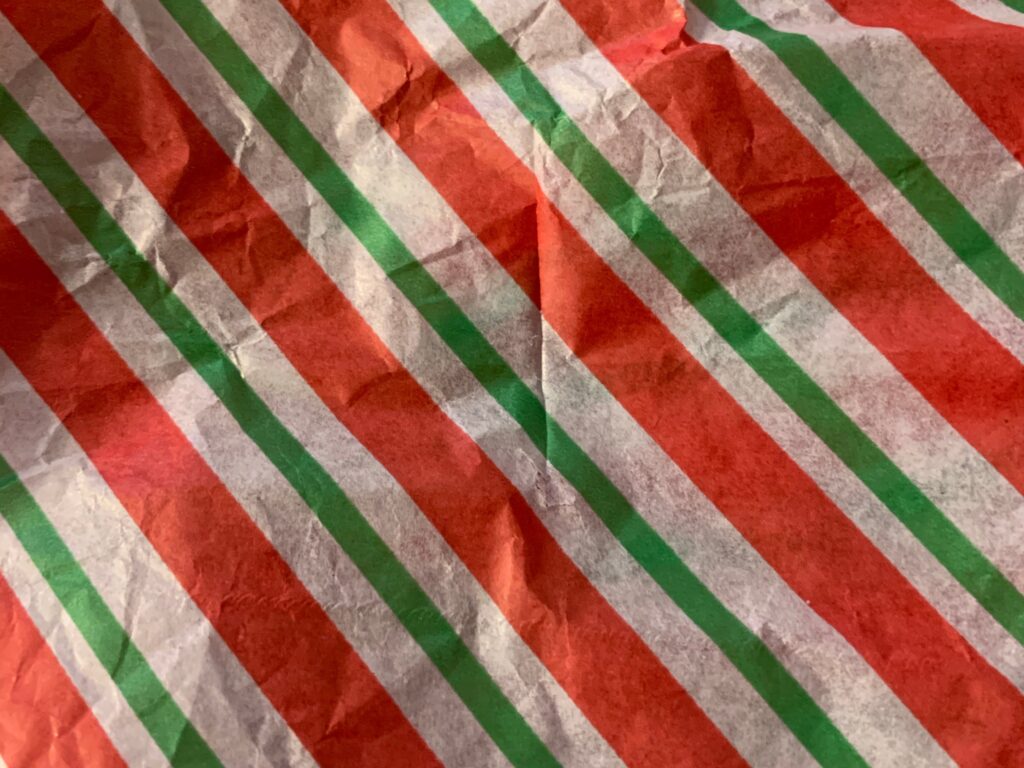 Vibrant diagonal red green and white stripes on paper
