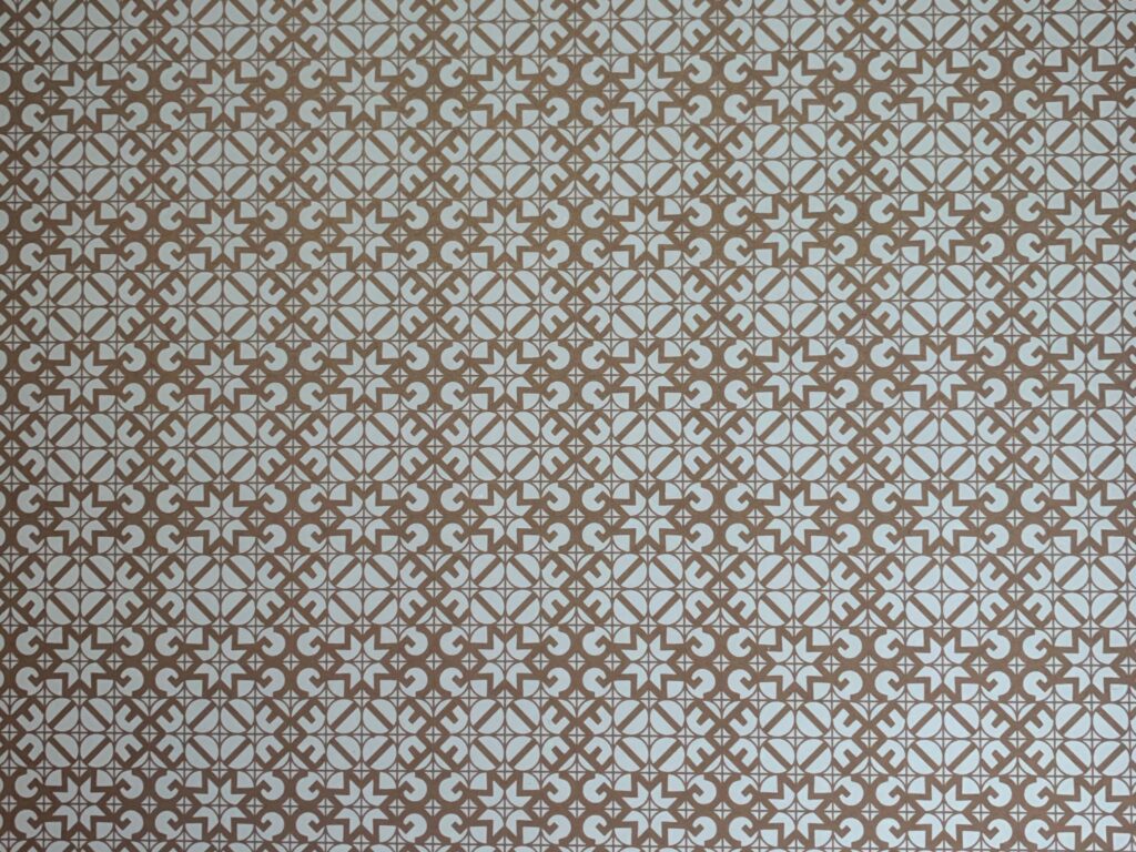 Decorative tiling with intricate pattern featuring white and brown