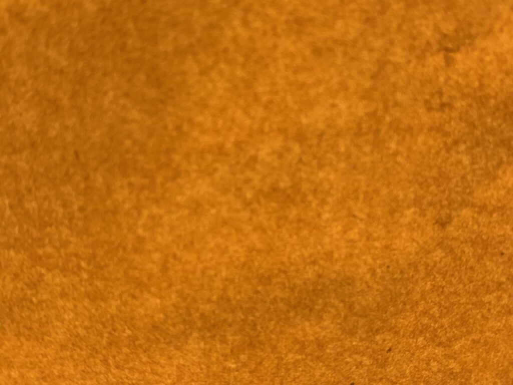 Extreme close up of felt like golden brown paper with depth of field