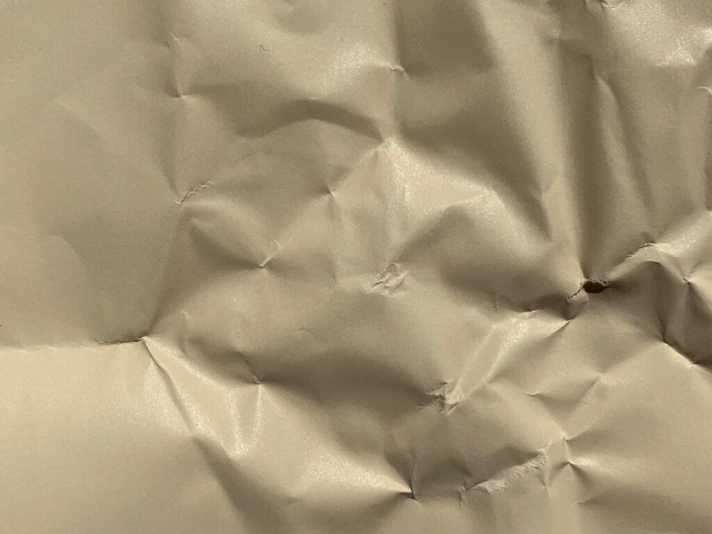 Tan semi-gloss paper with wrinkles and folds