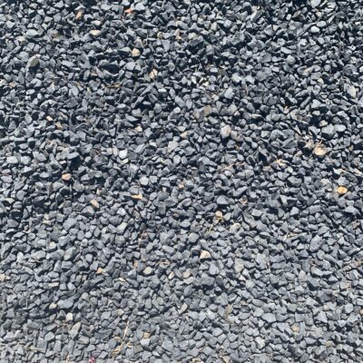 Small gray rocks with hard edges in flat patch of gravel