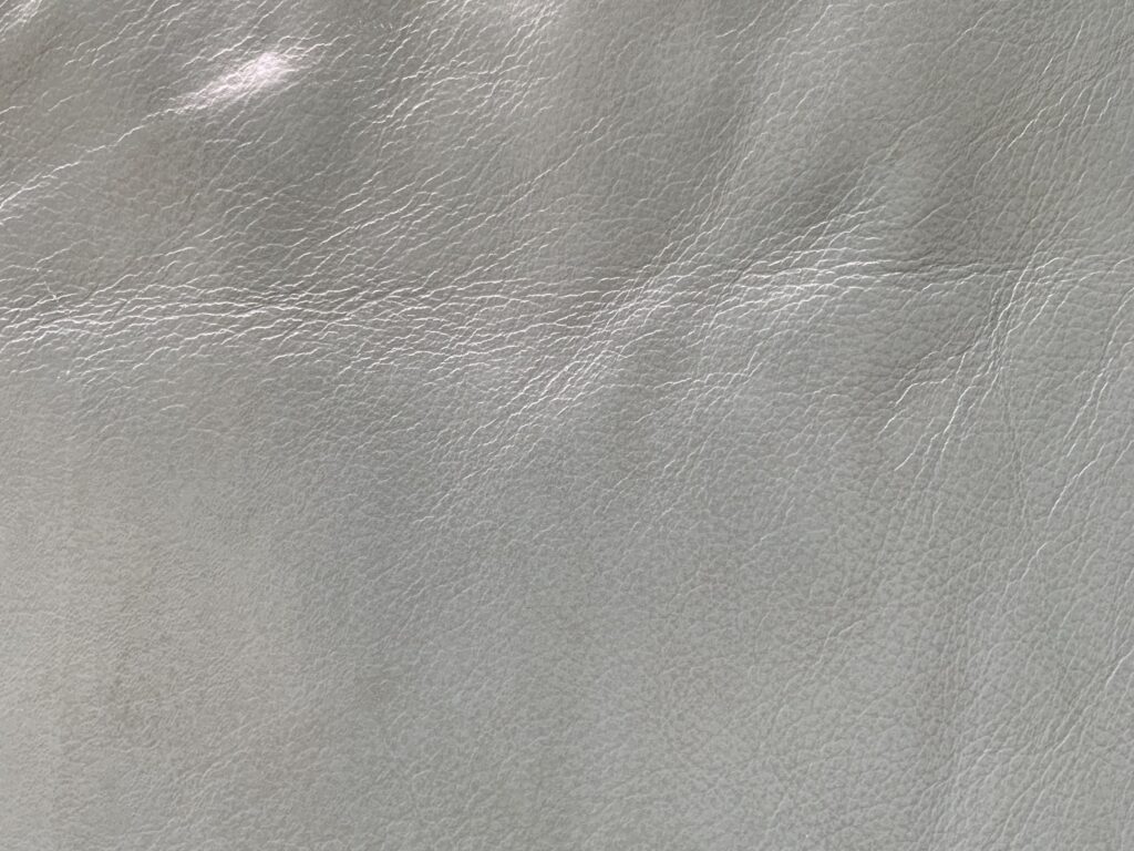 White leather with visible patterns of grain