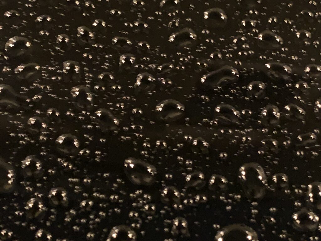 Water drops on polished black paint