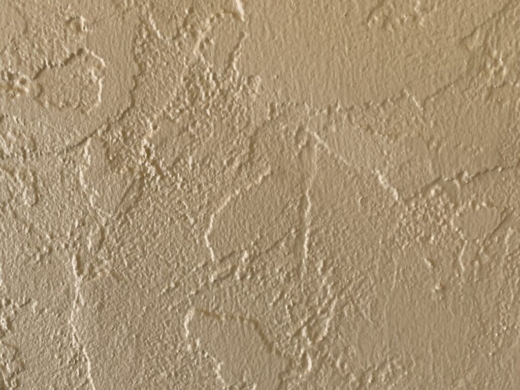 Pale yellow paint on concrete wall